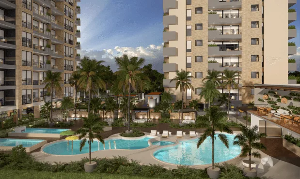 Vista de las piscinas de Element entre palmeras, con las torres alrededor
