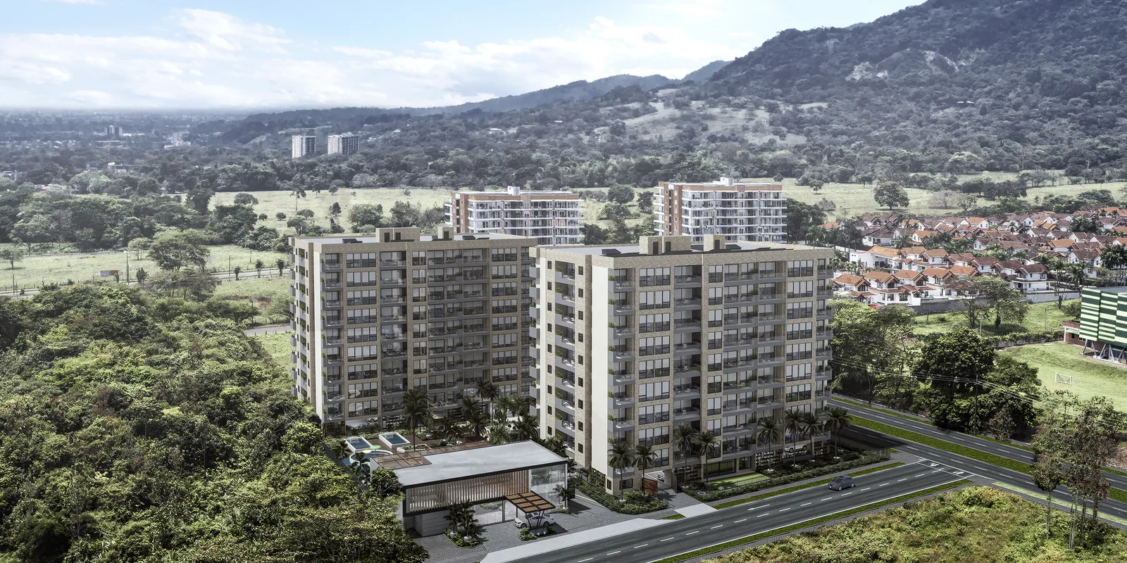 Vista aérea de las torres de Element Apartamentos en El Buque, Villavicencio, con la cordillera al fondo y la avenida al frente