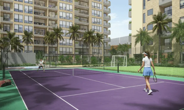 Cancha de tenis de Element rodeada de palmeras, con las torres al fondo